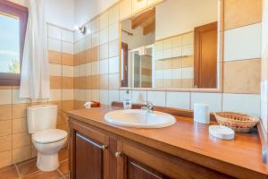 a bathroom with a sink and a toilet and a mirror at Can Pedro - Sa Torre Nova in Son Carrió +21 photos