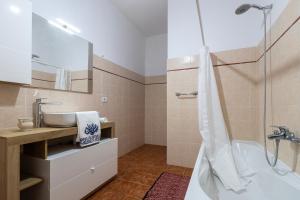 a bathroom with a tub and a sink at Casale- Il Giglio Rosa in Sorso