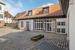 a large house with a courtyard in front of it at Remise im Wolkensteiner Hof in Gernsbach
