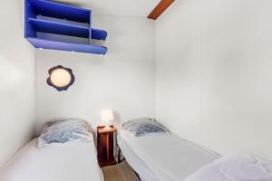 two beds in a room with white walls at Marinière in Sainte-Croix-de-Verdon +19 photos