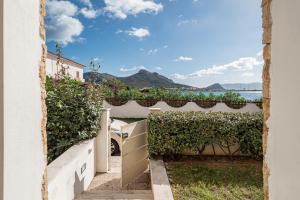 a view of the ocean from a house with a fence at Villa Cormorani 1 in Golfo Aranci