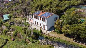 an aerial view of a house with solar panels on the roof at Monolocale Fattorialmare Viola in Camogli +9 photos