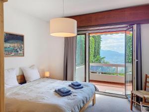 a bedroom with a bed and a large window at Apartment Superpanorama II by Interhome in Lugano