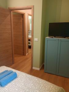 a bedroom with a bed and a television and a door at RHouse in Rho +18 photos