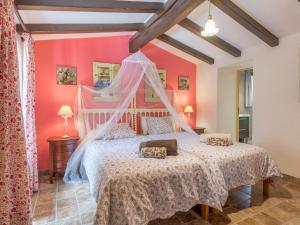 a bedroom with a bed with a canopy at Sa Barraca in Santanyi +17 photos