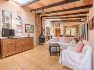 a living room with white furniture and a flat screen tv at Sa Barraca in Santanyi