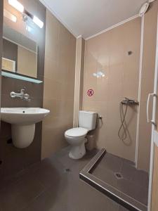 a bathroom with a toilet and a sink at Private Rooms Trakiets in Pomorie +10 photos