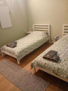 a bedroom with two beds and a rug at RHouse in Rho
