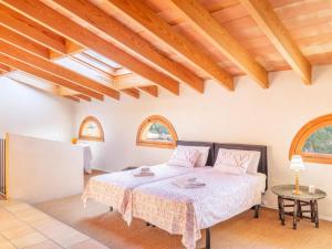 a bedroom with a bed in a room with wooden ceilings at Palma Townhouse Near the Beach in Palma de Mallorca