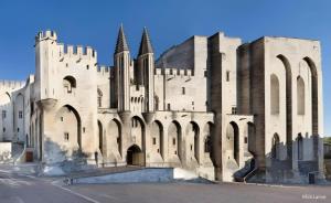 a large stone building with turrets and arches at Appartement De Standing Avignon in Avignon
