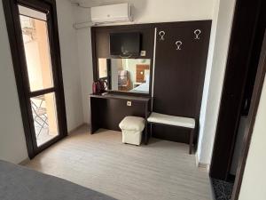 a room with a mirror and a desk and a chair at Private Rooms Trakiets in Pomorie