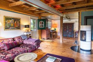 a living room with a couch and a table at Reetdachhaus Bischoff in Kuden