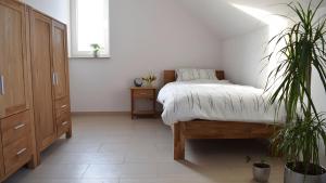 a bedroom with a bed and two potted plants at Ferienwohnung Wilhelmshof in Sinzig