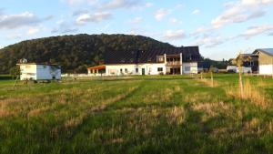 a house in a field with a hill in the background at Ferienwohnung Wilhelmshof in Sinzig +3 photos