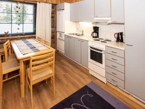 a kitchen with white appliances and a wooden floor at Holiday Home Kantapää d3 by Interhome in Luosto +14 photos