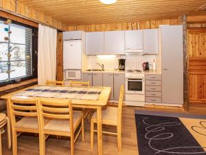 a kitchen with a dining room table and chairs at Holiday Home Kantapää d3 by Interhome in Luosto