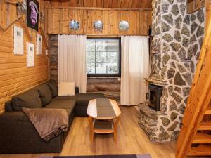 a living room with a couch and a fireplace at Holiday Home Kantapää d3 by Interhome in Luosto