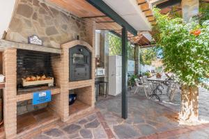 an outdoor pizza oven on a patio at Casa Roque in Monachil