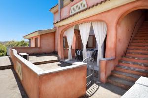 a house with a staircase leading to the front yard at Granito's in Monte Petrosu
