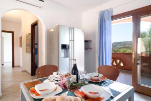 a dining room with a table and a refrigerator at Granito's in Monte Petrosu +17 photos