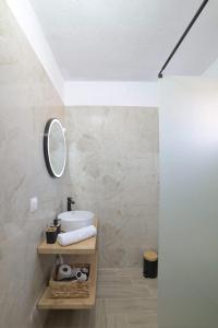 a bathroom with a sink and a mirror at Sunset View House In Chalkidiki in Nea Potidaea