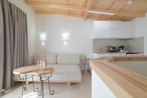 a kitchen and a living room with a couch and a table at Sunset View House In Chalkidiki in Nea Potidaea +44 photos