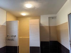 a bathroom with a shower with black and white tile at Villa Rest Ilijas 4 bedrooms in Ilijaš +79 photos
