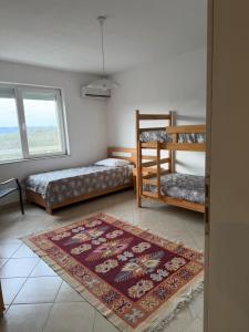 a room with two bunk beds and a rug at Villa Rest Ilijas 4 bedrooms in Ilijaš