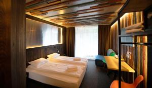 a bedroom with two beds and a desk and a book shelf at LOFT Hotel & SPA in Bukovel
