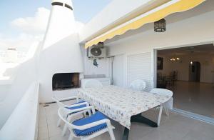 a table and chairs on the balcony of a house at Magnific 3-bedroom beach Bungalow in Adeje