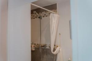 a bathroom with a shower with a shower curtain at Chambre Armand in Louvigny +12 photos