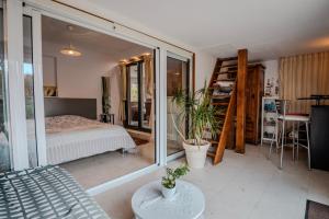 a bedroom with a bed and a large glass window at Chambre Armand in Louvigny