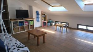 a living room with a tv and a table at Baywatch Penthouse in Altafulla