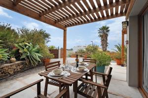a wooden table and chairs on a patio at Casa La Plaza in El Paso