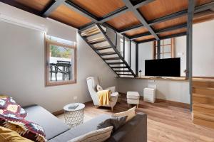 a living room with a couch and a tv at Casa La Plaza in El Paso