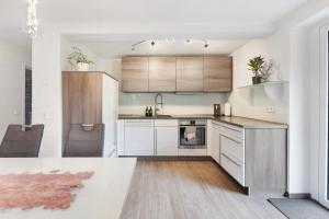 a kitchen with white cabinets and a white counter top at Helgas Horizon in Rottweil