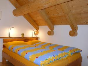 a bed in a room with a wooden ceiling at Holiday Home Rustico La Dimora by Interhome in Malvaglia