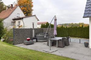 a patio with an umbrella and a table and chairs at Helgas Horizon in Rottweil