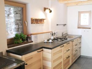 a kitchen with a sink and a stove at Holiday Home Rustico La Dimora by Interhome in Malvaglia