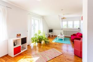 a living room with a red couch and a table at Elstar in Stockach
