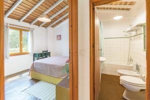 a bathroom with a bed and a toilet and a sink at Sesmarias Dos Nobres in Azinheira dos Barros +37 photos