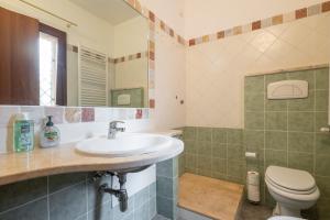 a bathroom with a sink and a toilet at Casa Annabella in Sarroch