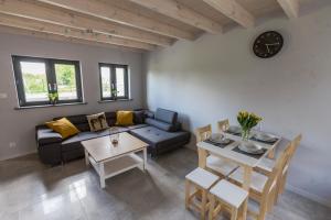 a living room with a couch and a table at Domki u Bazyla in Sarbinowo
