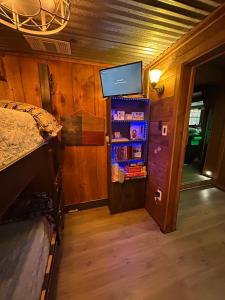 a bedroom with a bed and a tv on a wall at Prickly Pear - Rustic Cabin in New Braunfels +18 photos