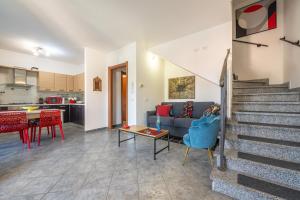 a living room with a couch and a table at Casa Annabella in Sarroch