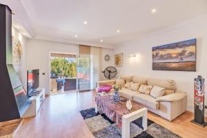 a living room with a couch and a tv at Serra Fuster - Casa Tolleric in Llucmajor
