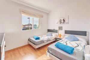 a bedroom with two beds and a window at Serra Fuster - Casa Tolleric in Llucmajor +19 photos