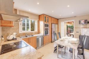 a kitchen with a table and a dining room at Serra Fuster - Casa Tolleric in Llucmajor