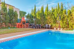 a swimming pool in a yard with a table and chairs at Serra Fuster - Casa Tolleric in Llucmajor