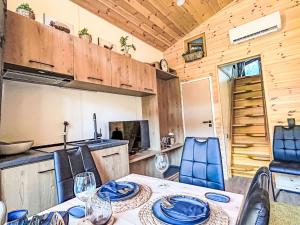 a kitchen and dining room with a table and chairs at Holiday Home Tiny Haus Glockenalm- Haus MaRe by Interhome in Aurach